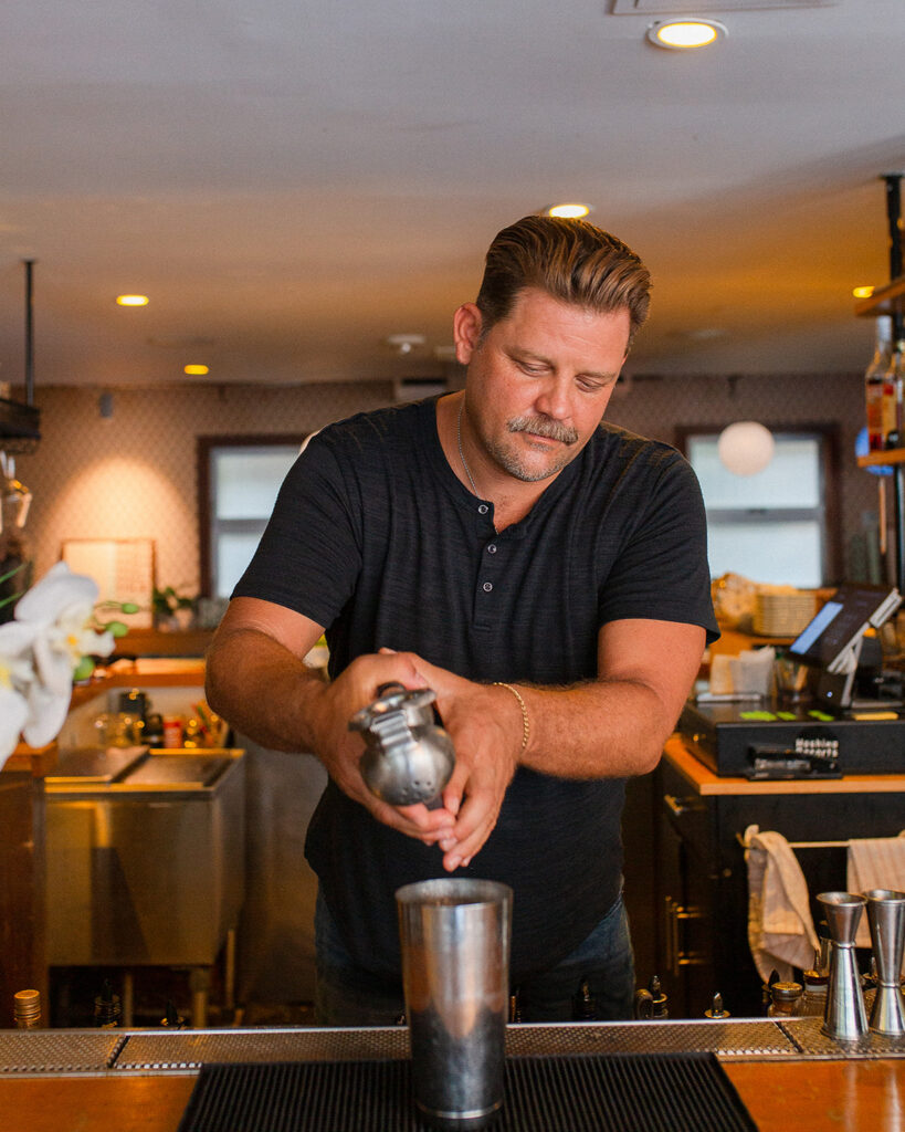 Christian bar czar pouring a drink
