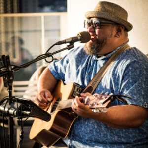 person playing a guitar while seated